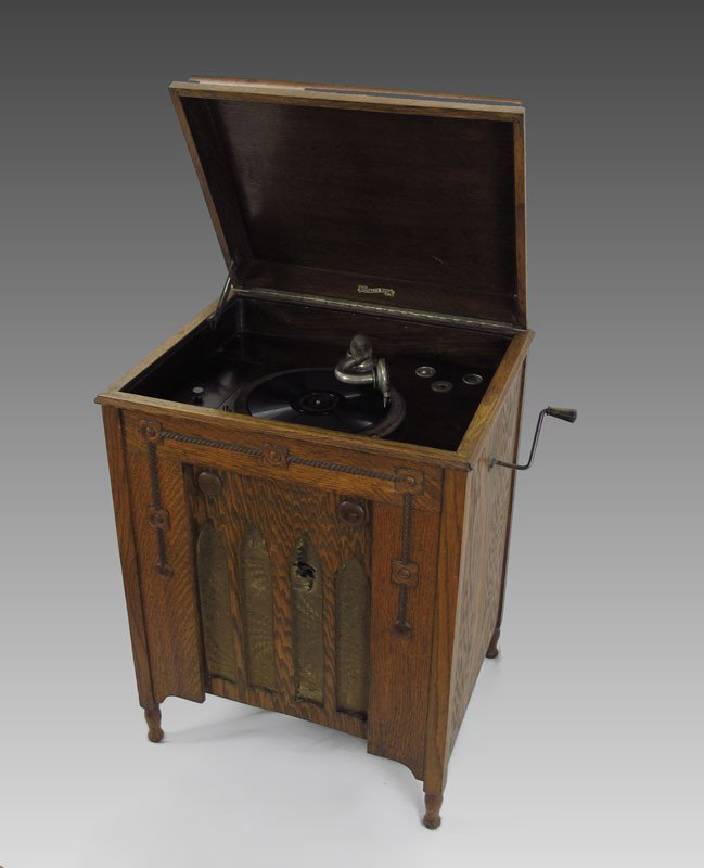 ENGLISH WIGFALLS ROYAL FLOOR MODEL PHONOGRAPH: ENGLISH WIGFALLS ROYAL FLOOR MODEL PHONOGRAPH: Mixed wood with tiger oak case, hinged lid with support. Crank and platter are currently working fine, cannot guarantee to continue. Sold with approx. 13