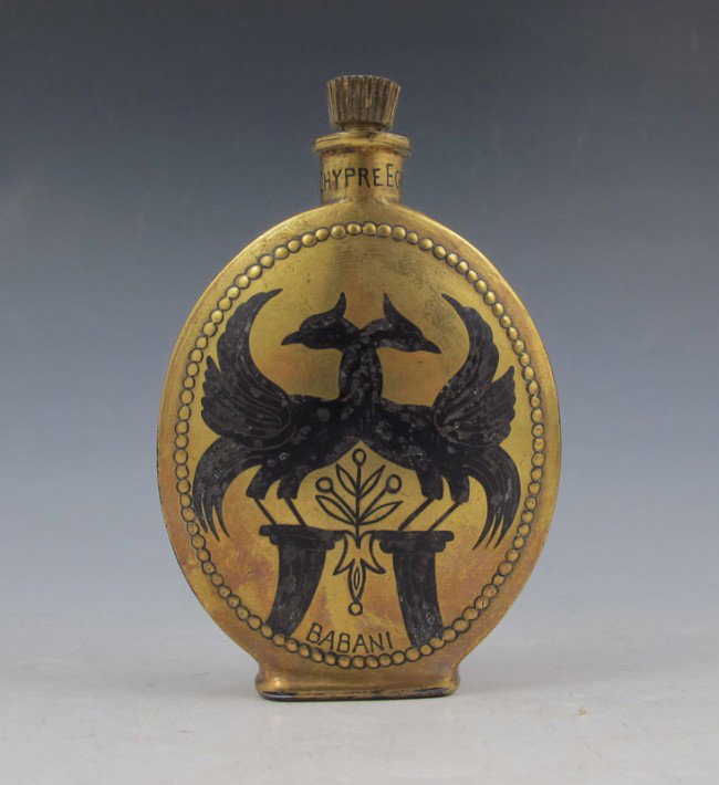 DEPINOIX BABANI CHYPRE EGYPTIAN PERFUME BOTTLE: DEPINOIX FOR BABANI CHYPRE EGYPTIAN PERFUME BOTTLE: Babani of Paris first introduced Chypre Egyptian in 1919 and it in the Elizabeth Arden Salons. The clear glass bottle covered in gilt and black enam