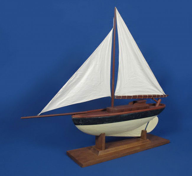 LARGE WOOD POND BOAT ON STAND: LARGE WOOD POND BOAT ON STAND: Mid 20th century hand crafted and painted pond boat with 2 canvas sails. Boat measures 32" h. x 40" x 6 1/2". Sold with wood stand 6" x 27 1/4" x 8".