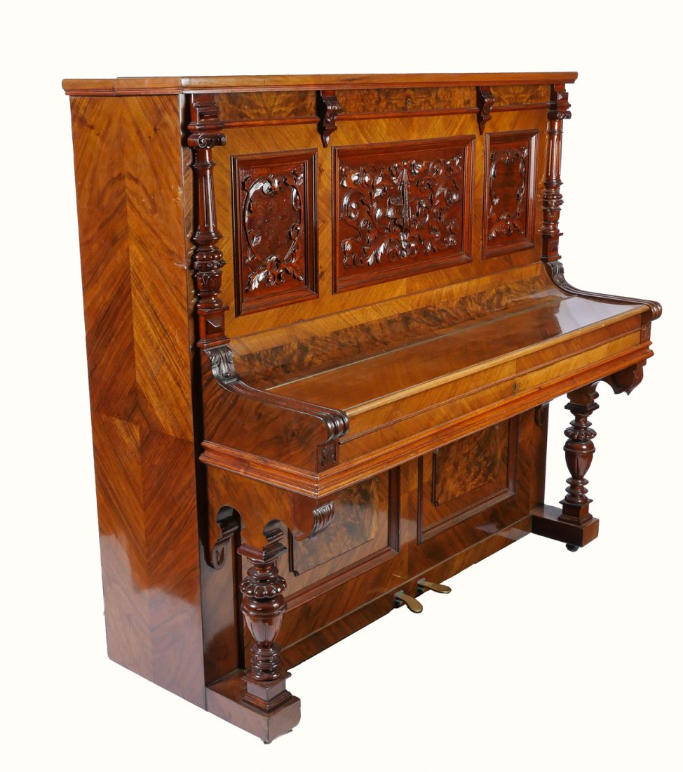 HIGHLY CARVED GERMAN UPRIGHT TRAUTWEIN PIANO: HIGHLY CARVED GERMAN UPRIGHT TRAUTWEIN PIANO: Serial #24708, circa 1910. Having carved foliate & instrumental panels, flanked by finely carved half-columns. Incised "T. Trautwein, Berlin", below sheet