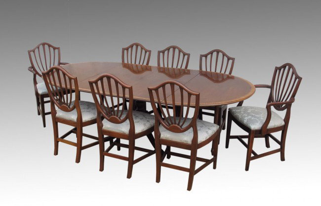 HICKORY CHAIR CO. DINING TABLE w/ 8 CHAIRS: HICKORY CHAIR CO. DINING TABLE AND 8 CHAIRS: Oval pedestal dining table with 2 leaves, 4 splayed legs on casters. 2 arm and 6 straight shield back chairs with soft blue damask upholstered seats. Table