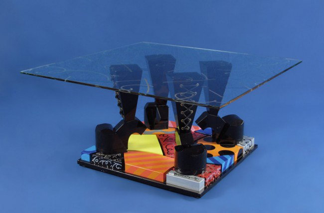 ROMERO BRITTO TABLE SCULPTURE: BRITTO, Romero, (Brazilian, 1963-): Acrylic painted wood and glass sculpture table with a high heeled boot motif, 24 1/2" square, etched glass top 36" square, signed and numbered 17 of 35, 18"h.