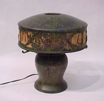 HEINTZ ART METAL BRONZE TABLE LAMP: HEINTZ ART METAL TABLE LAMP: Sterling design on bronze with a vivid green patina. The cut out designs on the removable shade are highlighted by silk lining. Paper label, 11"h., shade is 10" dia., sing