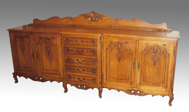 COUNTRY FRENCH OAK SIDEBOARD: COUNTRY FRENCH OAK SIDEBOARD: Carved backsplash with shaped top. 4 carved doors with 5 central drawers, carved apron and feet. 47" h. x 103" x 22 1/2".