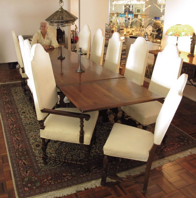 14 PC SPANISH COLONIAL DINING SET: 14 PIECE SPANISH COLONIAL DINING SET WITH IRON STRETCHERS: Draw leaf TABLE 30" h. x 76" x 36 1/2", expands to 136" fully open. 12 CHAIRS with turned legs, white upholstered backs and seats, 49" h. x 1