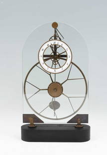 FRENCH GREAT WHEEL SKELETON CLOCK: FRENCH GREAT WHEEL SKELETON CLOCK: exposed brass movement on a arched glass frame and ebonized oval base. Enameled face. Approx. 18.25" h x 11" w x 3.5" d.