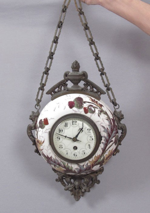FRENCH PORCELAIN HANGING CLOCK: FRENCH PORCELAIN HANGING CLOCK: Porcelain case with raised thistle design. Cast metal accents and mounts. Beveled glass crystal with porcelain face, Arabic numerals. Unknown maker signed movement, anc
