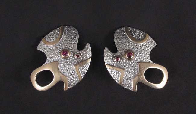 STERLING & 18K EARRINGS FREEFORM : STERLING & 18K EARRINGS: Match to the previous lot. Sterling and 18K yellow gold earrings with a freeform shape contain four round mixed cut rubies. Weight: .25 Ct. Approx. The rubies are bezel set. H