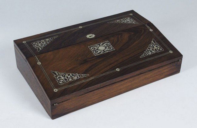 VICTORIAN MOTHER OF PEAL INLAY TRAVEL DESK: VICTORIAN MOTHER OF PEAL INLAY TRAVEL DESK: String and floral mother of pearl inlaid case with purple velvet writing surface, compartmented cubby holes. Key lock still functions. 3 3/4" h. x 16" x 10"
