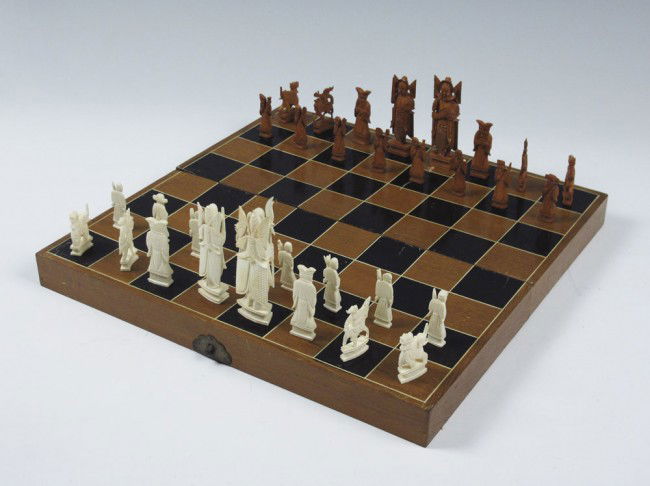 CHINESE CARVED IVORY CHESS SET: CHINESE CARVED IVORY CHESS SET: Royalty King & Queen, wise man bishops, soldier on horse knights, elephant rooks. Kings measures 4 1/2". h. Sold with game board case. 3" h. x 16" x 8".