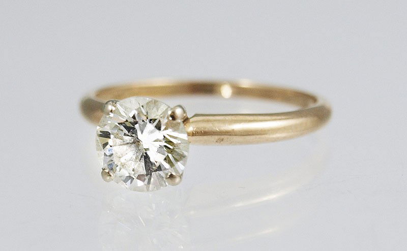 1 CT DIAMOND SOLITAIRE 14K GOLD RING: 1 CT DIAMOND SOLITAIRE 14K GOLD RING: 14K yellow gold ring contains one round brilliant cut diamond. Weight: 1.03 Ct. Approx. Rated VS2 in clarity and H in color. The diamond is prong set. Weight: 1.7