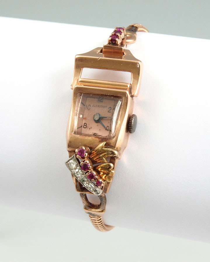 ART DECO 14k ROSE GOLD OLLENDORF WRISTWATCH: OLLENDORFF ART DECO LADIES 14K GOLD WRISTWATCH: Swiss made 17 jewel watch in running order. Gold band and case. Accented with approx. .10 Ct diamonds and rubies. Original band with safety latch and ch