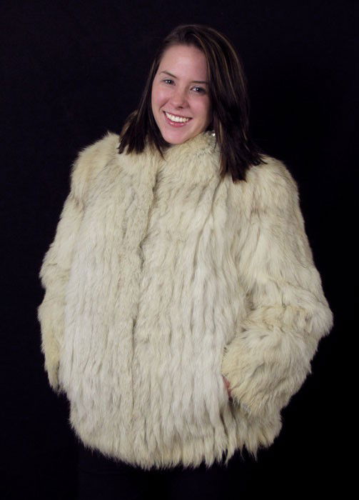 SAGA SHORT COLLAR WHITE FUR JACKET: SAGA SHORT COLLAR WHITE FUR JACKET: White short collared fox fur jacket with strip style pattern, peach lining. Saga Fox Furs by Wrubele Kozin, Birmingham, Michigan. Beige / light tan velvet strips al