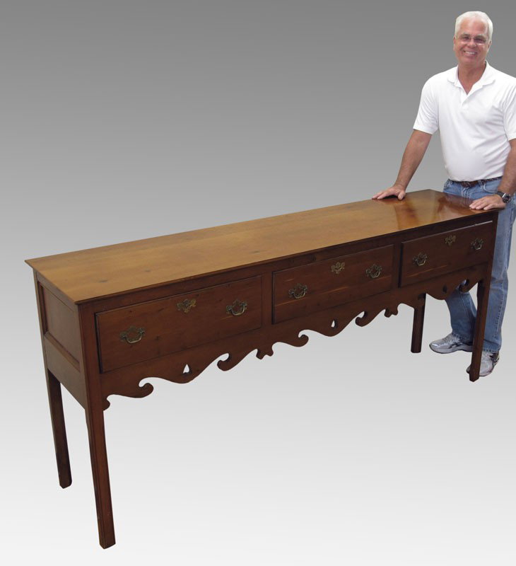 A MORE RECENT AMERICAN PINE SIDEBOARD: A MORE RECENT AMERICAN PINE SIDEBOARD: Three drawers, over a pierced and shaped skirt. Interior with felt lined drawers. Approx. 36"h. x 80 1/2" long x 18 1/2".