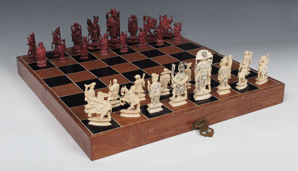 CHINESE CARVED IVORY CHESS SET: CHINESE CARVED IVORY CHESS SET: Complete set with intricate carving and additional scrimshaw on king, queen, and bishops. King measures 4 1/4''. Sold with felt lined case / game board. Case measures 4