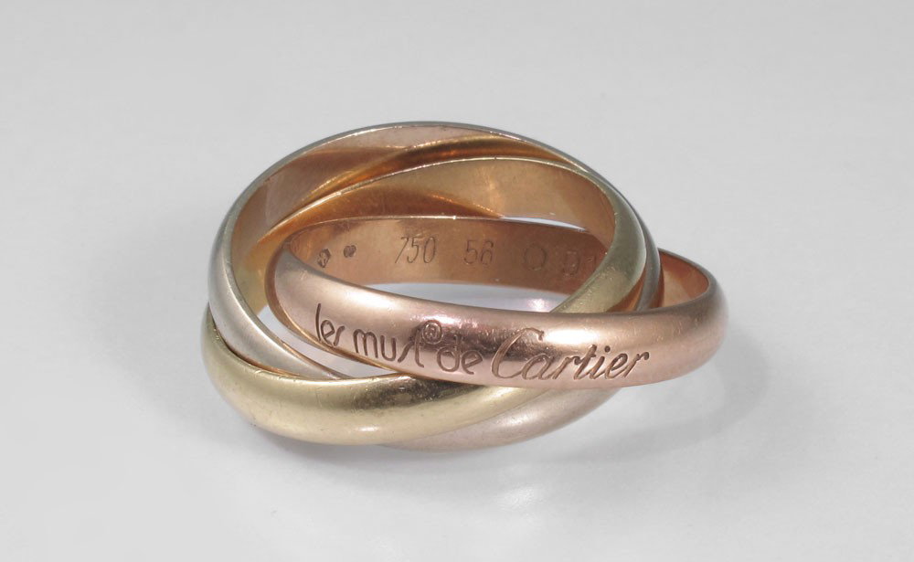 LES MUST DE CARTIER TRI COLOR GOLD ROLLIN G BAND R: CARTIER 18K GOLD TRI-COLORED "ROLLING RINGS" BANDS: 18K white, yellow and rose gold "Les Must de Cartier" 3 band ring. Weight: 9.1 grams. Size: 6.5