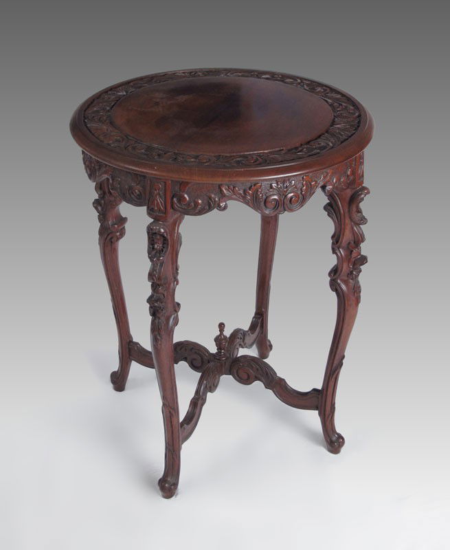 CARVED LAMP TABLE: CARVED LAMP TABLE: Relief carved top, carved skirt, carved legs joined by stretcher. 28"h.x 20" dia.