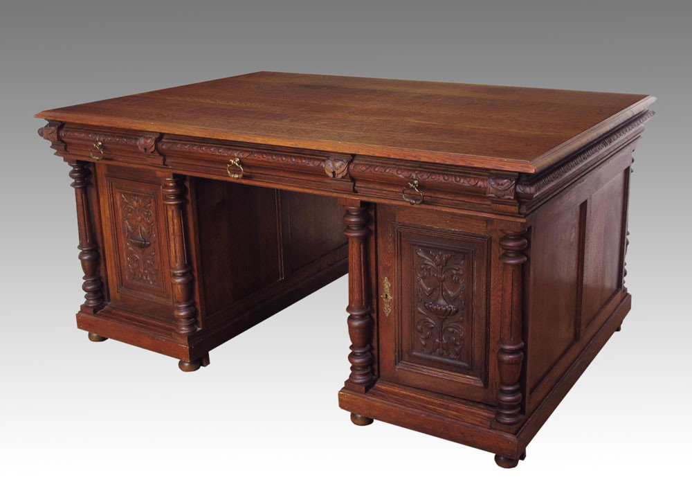 TIGER OAK PARTNERS DESK: A GRAND HORNER QUALITY OAK PARTNERS DESK: 3 drawers over 2 doors with carved columns, Art Nouveau design carved on the door panels. Door open to reveal 3 drawers on one side and 3 shelves on opposite.