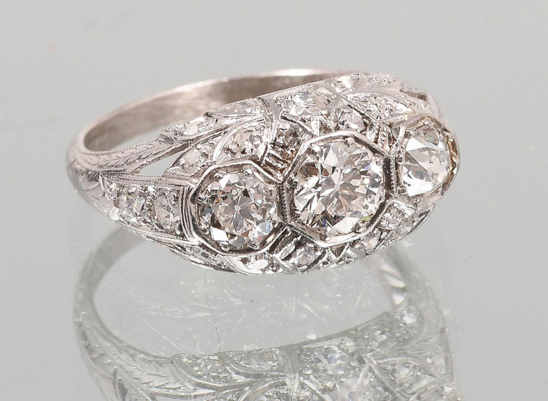 LATE EDWARDIAN PLATINUM 3 STONE DIAMOND RING: LATE EDWARDIAN PLATINUM 3 STONE 1.55 CTW DIAMOND RING: Beautiful detail in this late Edwardian 3 stone 1.55 CTW diamond ring set with an additional 25 period cut diamonds. Size 6. Sold with current Fl