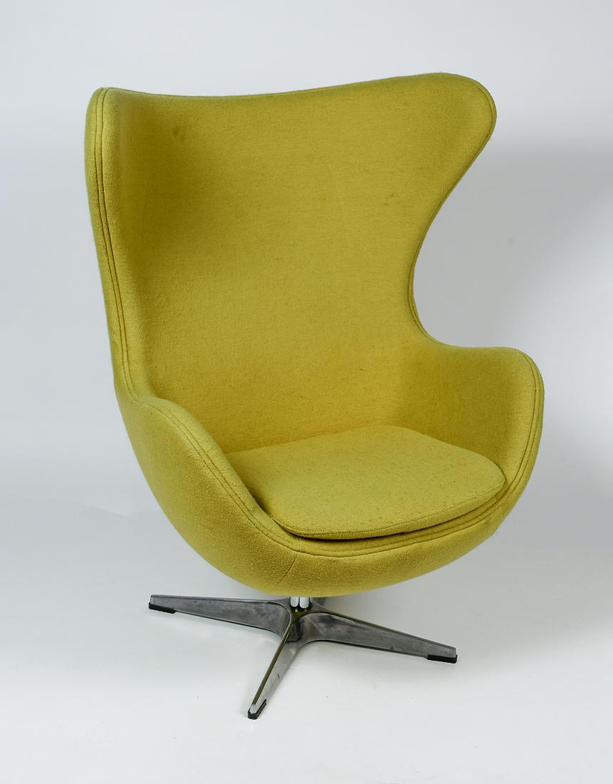 SWIVEL EGG CHAIR IN THE STYLE OF ''ARNE JACOBSEN'': SWIVEL EGG CHAIR IN THE STYLE OF ''ARNE JACOBSEN'': Egg chair, in the style of Arne Jacobsen, upholstered in a Tennis Ball Green Boucle fabric. Chromed swivel base with a handle that allows the chair 