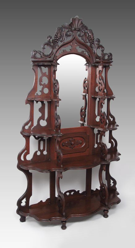 A GRAND VICTORIAN MIRROR ETAGERE: A GRAND VICTORIAN MIRROR ETAGERE: Carved crest with shell and grape vine motif over central mirror surmounted by 4 side shelves, all above 2 full length shelves. 80" h. x 49" x 14 1/2".