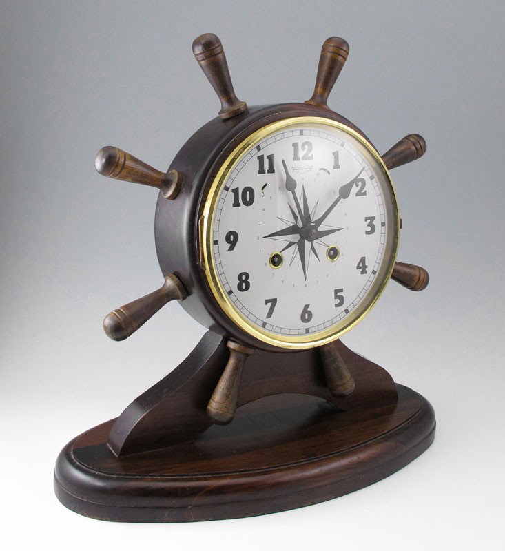 NEW ENGLAND CLOCK CO. SHIPS WHEEL CLOCK: NEW ENGLAND CLOCK CO. SHIPS WHEEL CLOCK: Mantle clock in the form of ships wheel by New England Clock Co. Farmington, Conn. Time and strike key wind movement, key in office. 13 1/2'' h. x 13 1/2'' x 6