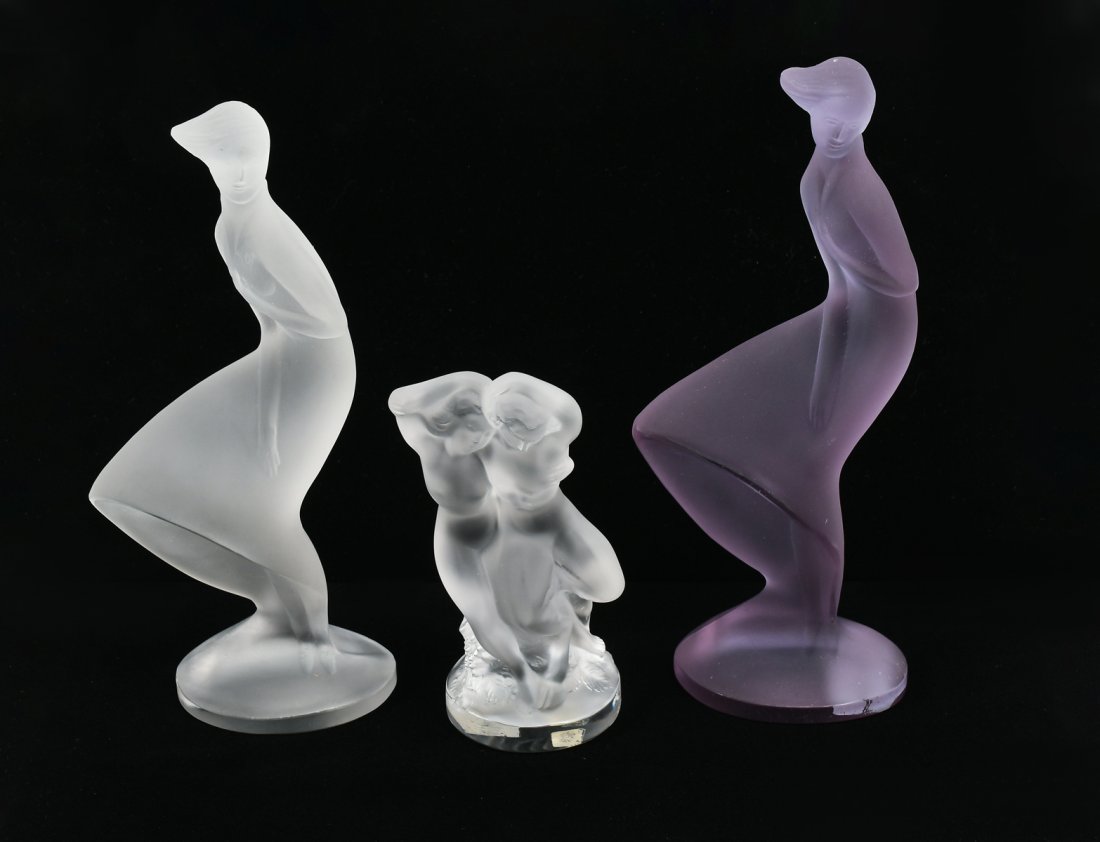 3 PC. FRENCH LALIQUE FEMALE & NUDE FIGURES: 3 PC. FRENCH LALIQUE FEMALE & NUDE FIGURES: Comprising; 2- Robed women in the wind, & 1- Double nude figure. All three with etched Lalique, France. Largest Approx. 8.75" h x 4" w x 2" d.