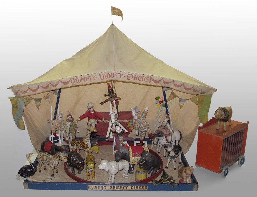 SCHOENHUT HUMPTY DUMPTY CIRCUS WITH TENT: SCHOENHUT HUMPTY DUMPTY CIRCUS WITH TENT: Approx. 34 pieces including the Menagerie Tent with original flags and partial labels, 37'' h. x 51 1/2'' x 25''. Figures and animals to include 2 part head c