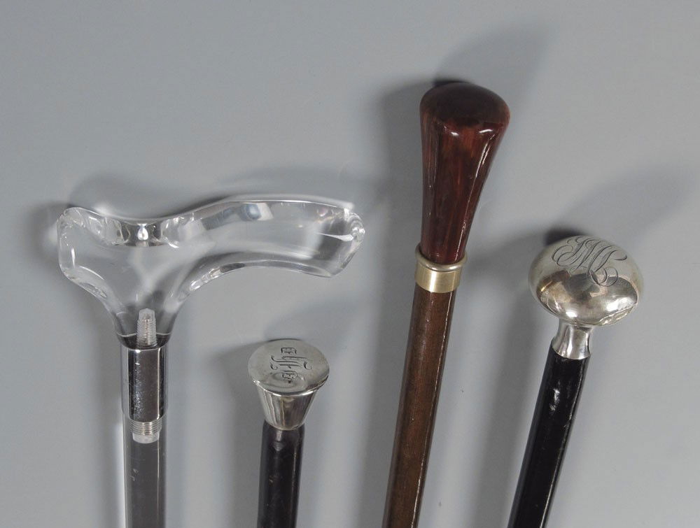 COLLECTION OF 4 WALKING STICKS: COLLECTION OF 4 WALKING STICKS: To include 1) Lucite cane, missing tip, 32 1/2'' l. 2) Monogrammed sterling handle with black painted shaft, metal tip. 39 3/4'' l. Note dent and dings to handle, dings