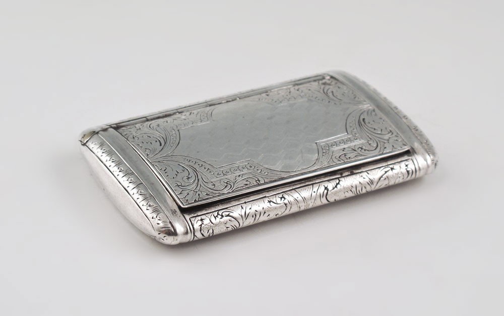 AUSTRIAN SILVER SNUFF BOX: AUSTRIAN SILVER SNUFF BOX: Engraved foliate scroll and geometric designs with vermeil interior, hinged lid. Austrian silver hallmark with unknown makers or town mark. 3 1/4" x 2". Approx. 2.7 troy oz.