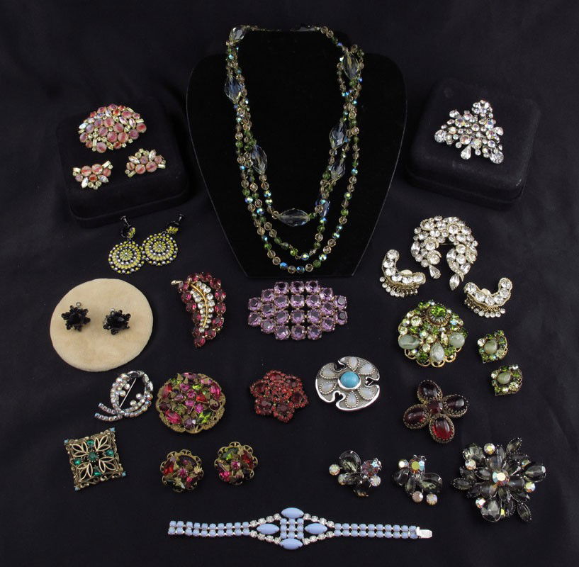COSTUME JEWELRY HOBE AUSTRIAN TRIFARI RHINESTONE: LOT OF COSTUME JEWELRY: To include, HOBE' brooch and earring set; AUSTRIAN & CZECHOSLOVAKIAN crystal pins; TRIFARI pin; JOAN RIVER dangle earrings; REGENCY brooch and earring set and a red brooch. Unm