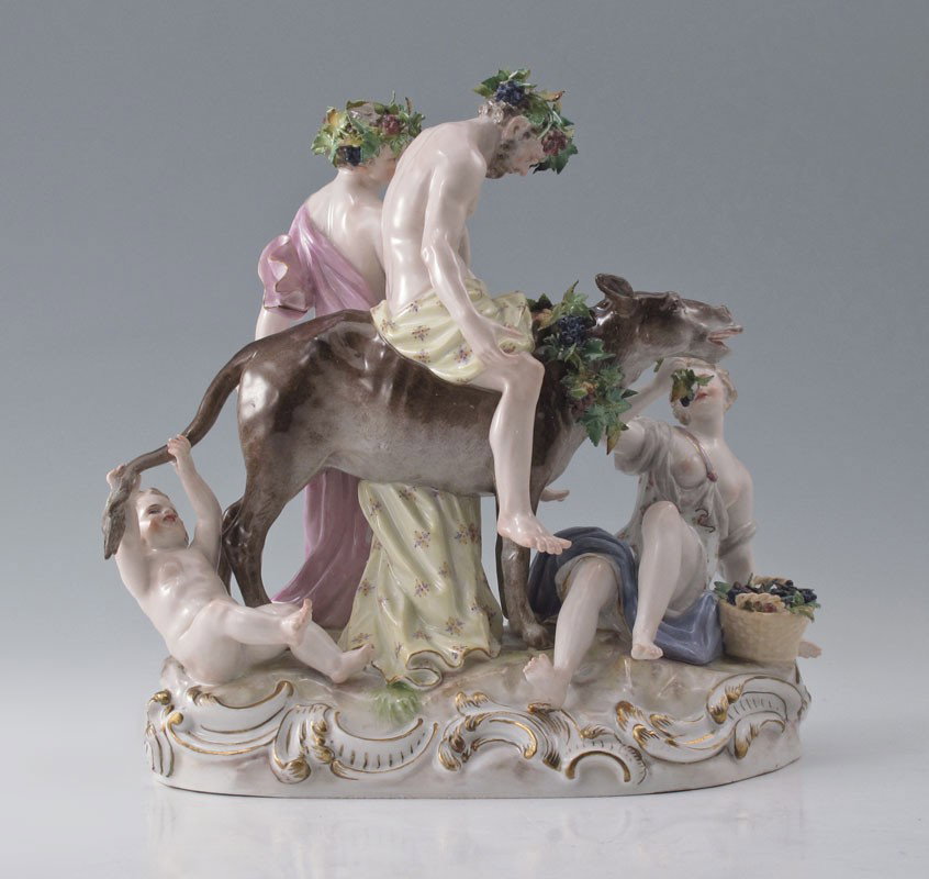 MEISSEN FIGURAL GROUP SILENUS ON A DONKEY: LARGE 4 FIGURE & DONKEY MEISSEN FIGURE: The drunken Silenus on a donkey, with attendants. The girl feeding grapes to the donkey, a putti at his tail. The rocky base with gilt scrolls. Blue cross sword