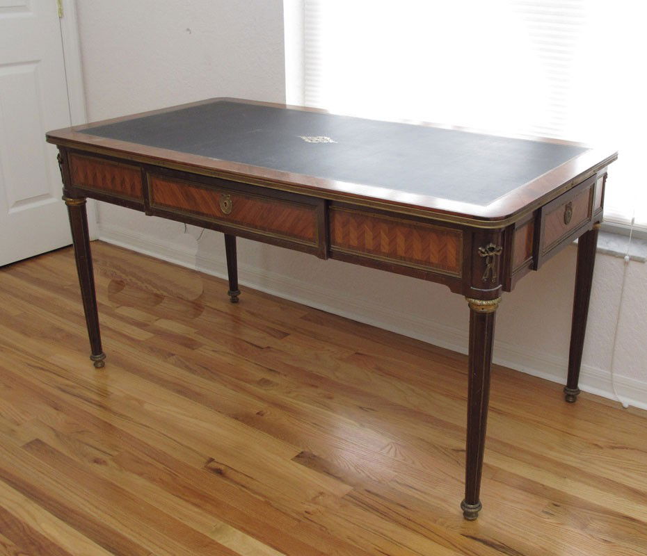 LOUIS XVI FRENCH ORMOLU WRITING TABLE: LOUIS XVI STTYLE FRENCH ORMOLU THREE DRAWER WRITING TABLE: Embossed black leather top, tapered reeded legs. Unusual with a drawers at each end. 30" h. x 59 1/4" x 29 3/4"