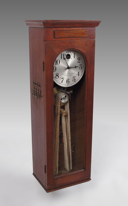 STANDARD ELECTRIC TIME CO. WALL CLOCK: STANDARD ELECTRIC TIME CO. WALL CLOCK: Oak case with Electric time only movement, silvered dial marked The Standard Electric Time Co., Springfield, Mass. Original ticket tape. Measures 37 3/4'' x 13 1
