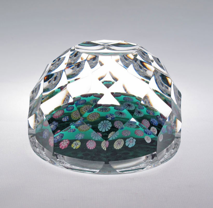 WHITEFRIARS CAITHNESS CANE GLASS PAPERWEIGHT: WHITEFRIARS CAITHNESS PAPERWEIGHT: In the original presentation box. Faceted body with cane base on green ground. 2 3/4'' x 2''.