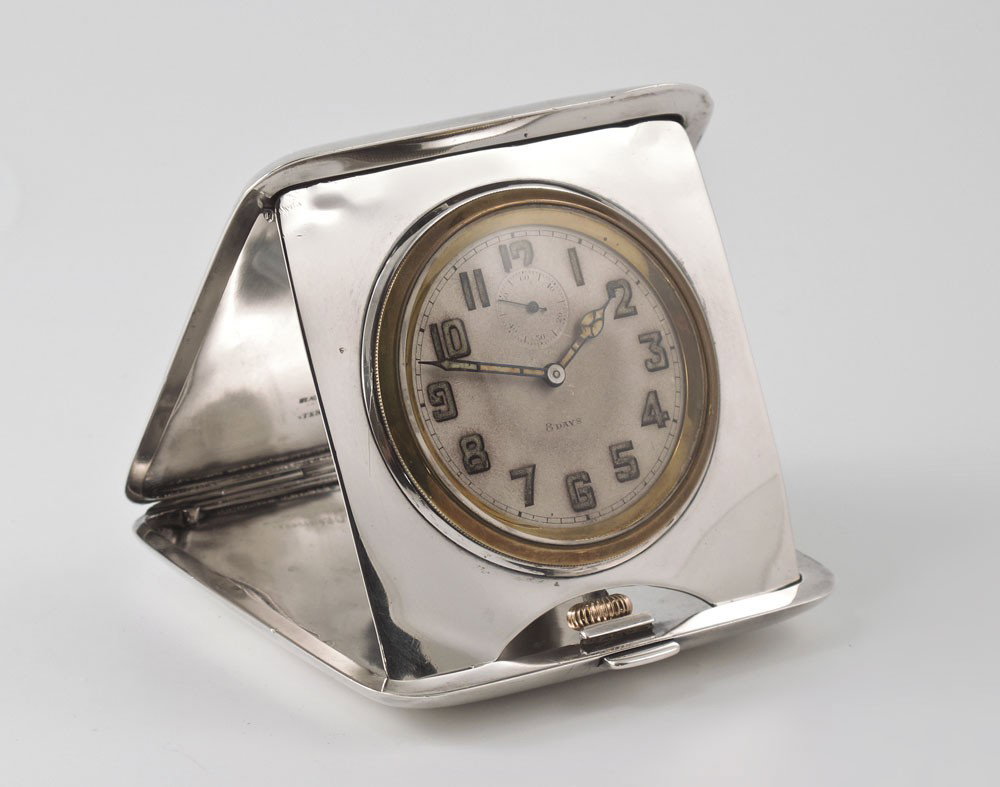 BLACK STARR & FROST STERLING TRAVEL CLOCK: BLACK STARR & FROST STERLING TRAVEL CLOCK: Sterling case with engraved design and monogrammed center medallion. 8 day pocket watch style movement. Push button clasp. 4 1/4'' x 3 3/4''.