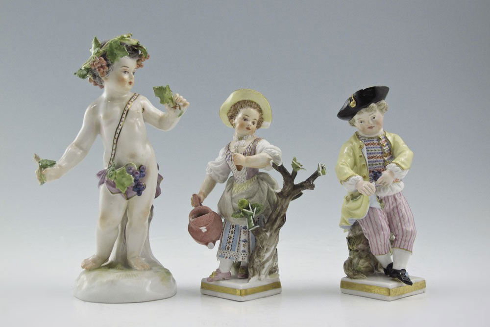 GROUP OF 3 MEISSEN PORCELAIN FIGURES: GROUP OF 3 MEISSEN PORCELAIN FIGURES: Bacchanalian child, 5" tall. Sold with the pair of garden figures, 4 1/4" tall. All with the Meissen cross swords mark.