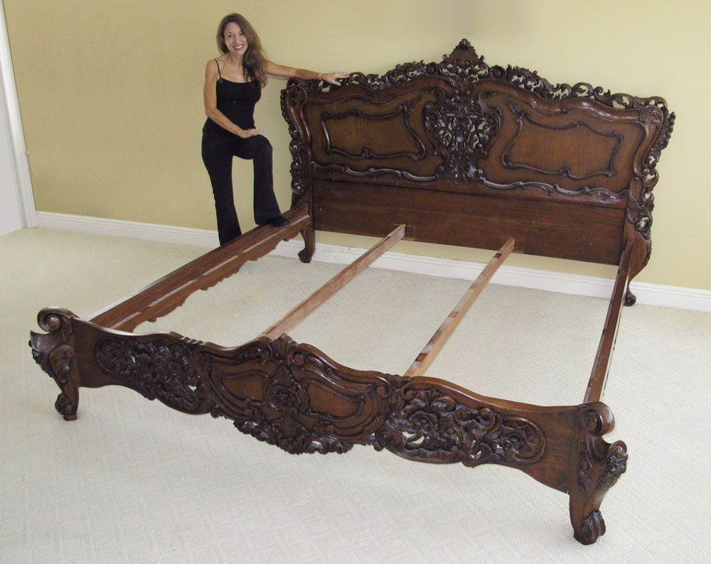 ORNATELY CARVED MAHOGANY BED: ORNATELY CARVED MAHOGANY BED: Ornately carved headboard, footboard, rails king size in the rococo style. Headboard 57 1/2" h. x 92" x 1 1/2", foot board 23" h. x 90 1/2" x 6", rails 78 3/4" long.