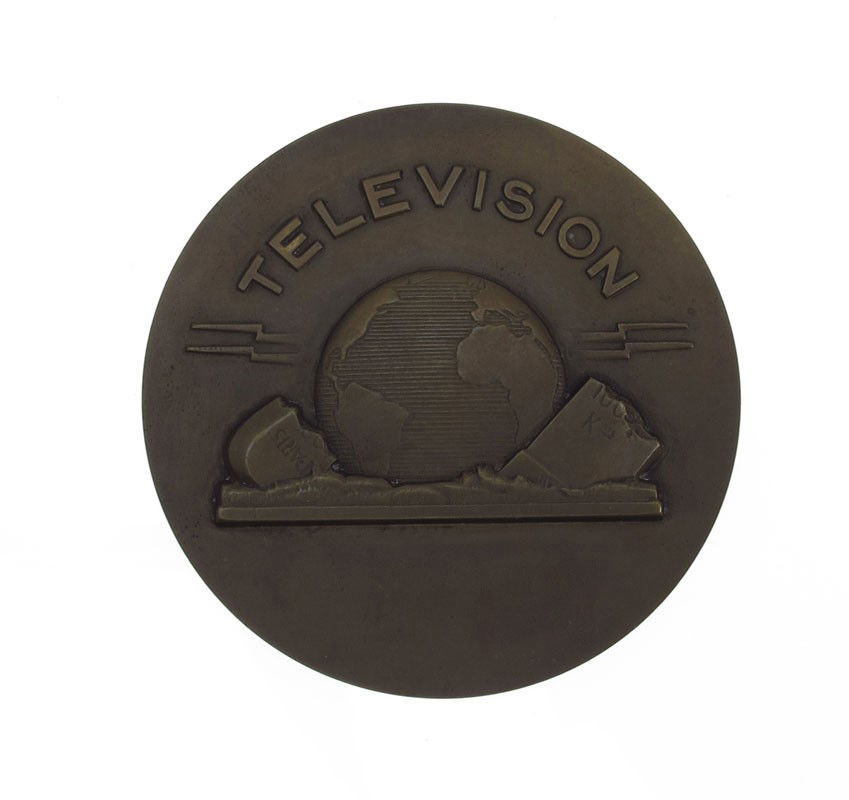 MAURICE GUIRAUD DECO TELEVISON MEDAL: GUIRAUD, Maurice, (French, 1881): Art Deco Bronze Medallion to Commemorate the Birth of Television, 2 5/8'' dia., incised signature, stamped 'Bronze'.