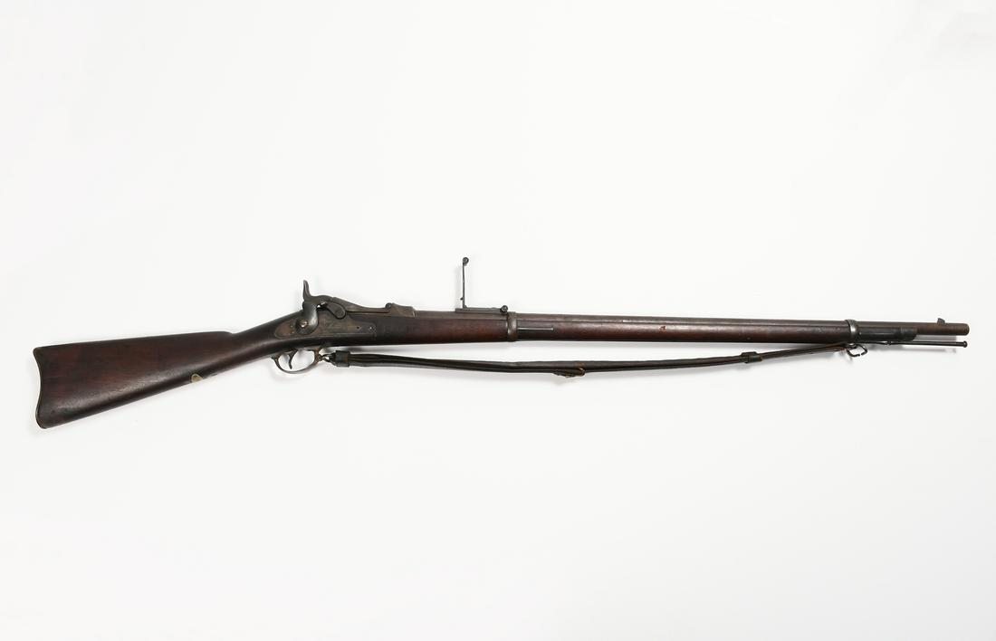 ANTIQUE MODEL 1884 US SPRINGFIELD TRAPDOOR RIFLE: ANTIQUE MODEL 1884 US SPRINGFIELD TRAPDOOR RIFLE: VP and Eagle head marks to the barrel, with a leather strap that has significant age, impressed Rock Island Arsenal 1903. As is condition.
