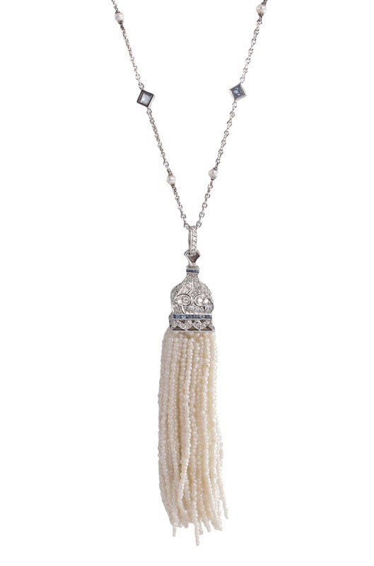 18K GOLD PEARL DIAMOND SAPPHIRE TASSEL NECKLACE: 18K GOLD AND DIAMOND, SAPPHIRE AND PEARL TASSEL NECKLACE: 18K white gold necklace with a tassel of 158 strands of white 1.5 mm cultured pearls. The chain and pendant also contain 128 round brilliant V