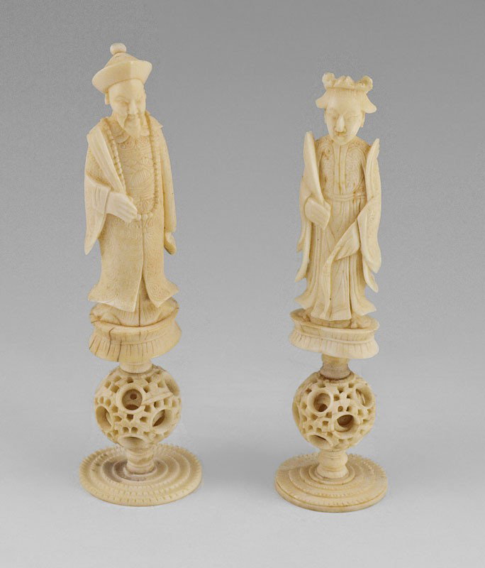 PAIR OF CARVED IVORY FIGURES ON MYSTERY BALLS: PAIR OF CARVED IVORY FIGURES ON MYSTERY BALLS: Carved ivory man and woman each affixed to carved ivory mystery ball bases. Man measures 5 3/4".