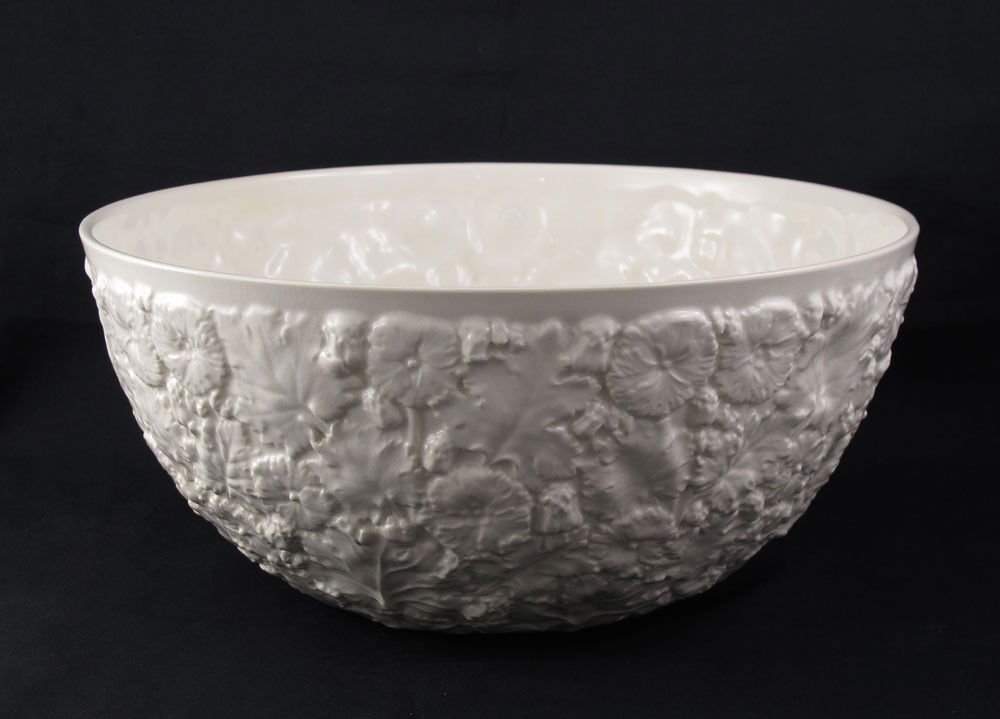 SPODE EARTHENWARE PUNCH BOWL: SPODE EARTHENWARE PUNCH BOWL: Large 12" dia. bowl, the exterior body with all over molded foliate pattern, cream color, 5 1/2" tall. Harvey Hanaford Miller/Charles Wiedemann Collection.