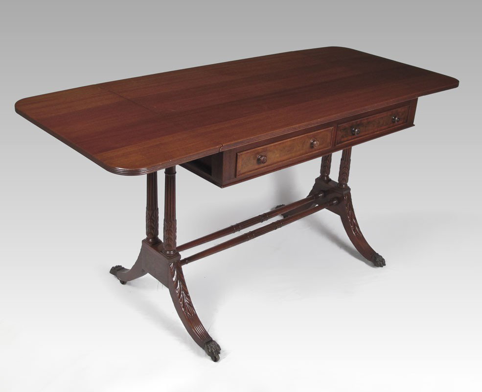 KITTINGER MAHOGANY 2 DRAWER DROP LEAF TABLE: KITTINGER MAHOGANY WRITING TABLE: Two half length drawers, two drop leaves, double pedestal joined by stretchers, splayed legs, brass covered feet on castors. 29 1/2" h. x 37" x 25 1/4".