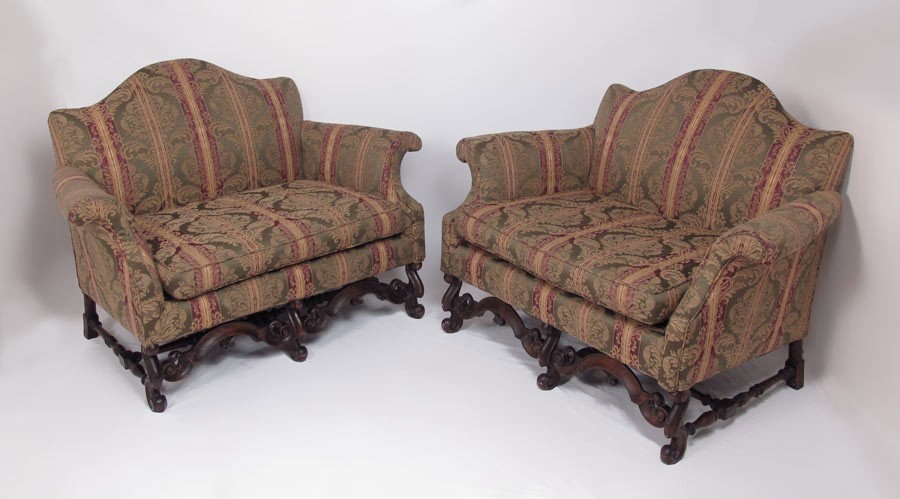 PAIR FLEMISH STYLE HUMP BACK SETTEE CHAIRS: PAIR OF CHIPPENDALE STYLE SETTEES: Flemish mahogany legs and stretchers, single cushions, hump back, rolled arms, A cozy 38" tall x 51" wide x 36" deep.