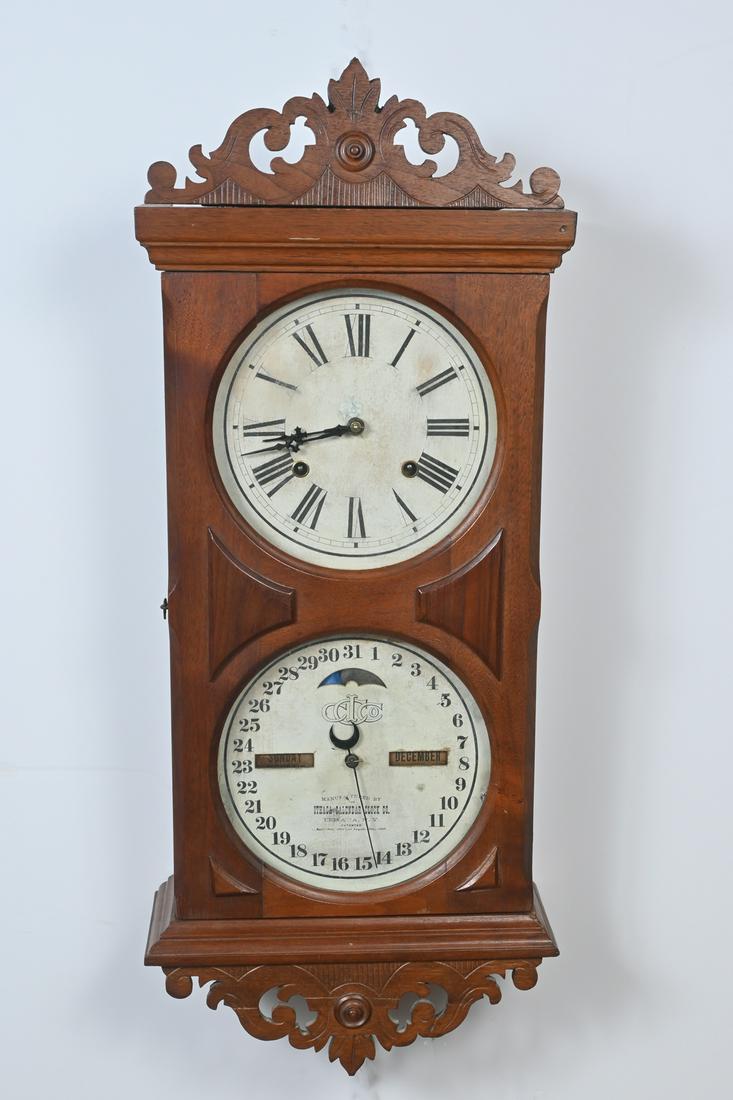 DOUBLE DIAL ITHACA WALL CALENDAR CLOCK: DOUBLE DIAL ITHACA WALL CALENDAR CLOCK: Ithaca Farmers No. 10 clock in wood case with two dials for time & date, and calendar movements for day & month. With original retail sticker instructions on ba