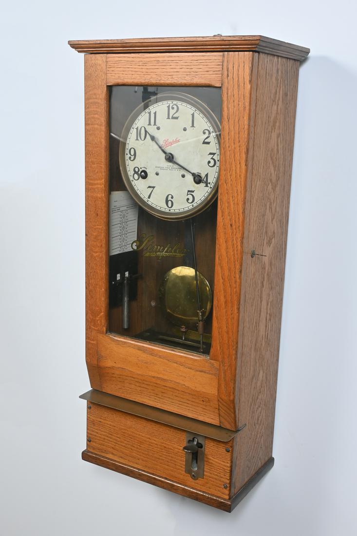 OAK SIMPLEX TIME RECORDER CLOCK WITH TIME CARDS: OAK SIMPLEX TIME RECORDER CLOCK WITH TIME CARDS: Simplex model T-10 punch clock in oak case with glass front door having reverse painted logo. Inside is a mechanized metal recording stamp activated by