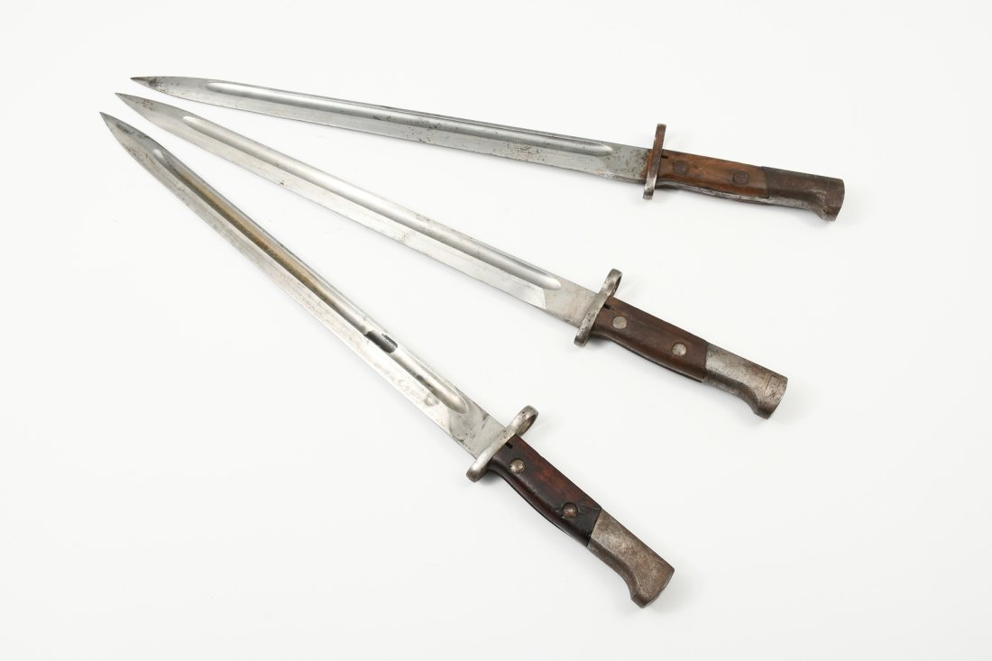 THREE EUROPEAN BAYONETS CIRCA 1900 OR EARLIER: THREE EUROPEAN BAYONETS CIRCA 1900 OR EARLIER: All with metal scabbards, approximately 21" in length.