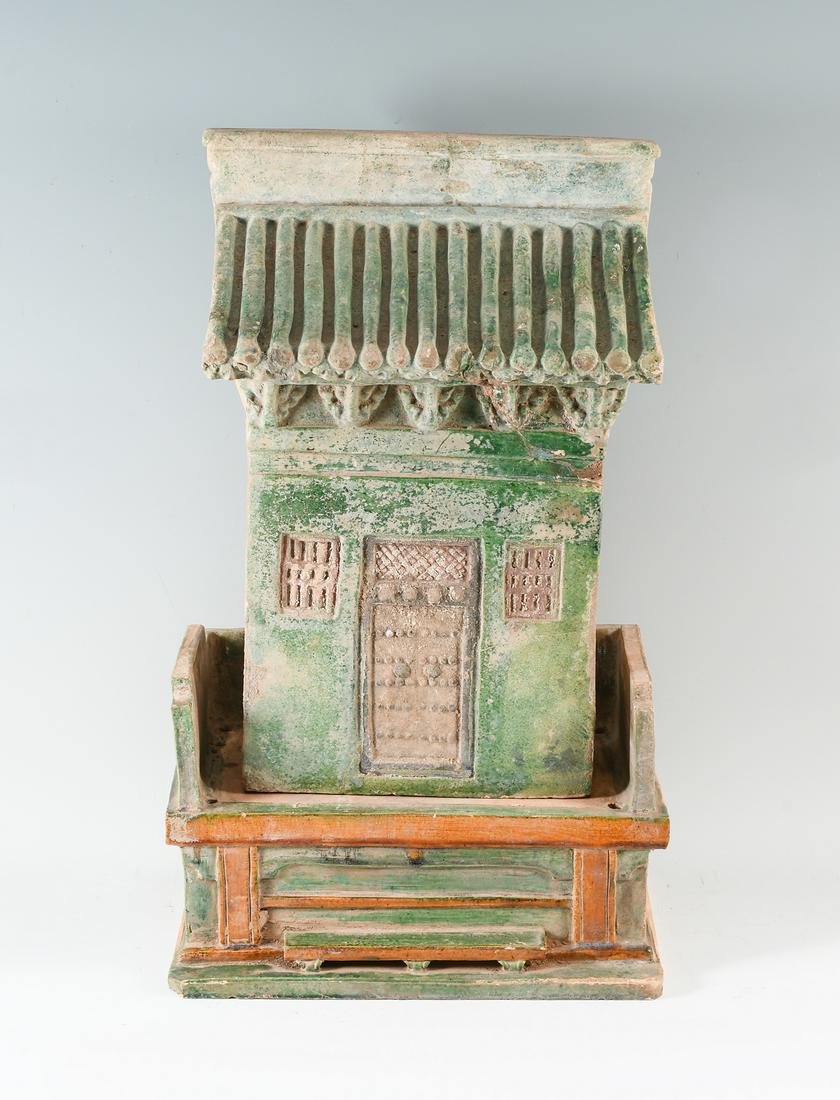 MING DYNASTY TERRACOTTA HOUSE MODEL & BASE: MING DYNASTY TERRACOTTA HOUSE MODEL & BASE: 2 pieces, the top being green glazed architectural model of a housefront with door flanked by two windows. Base altar sancai glazed in green, ochre, and bro