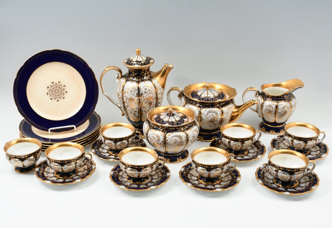 19 PC. KPM PORCELAIN TEA SET: 19 PC. KPM PORCELAIN TEA SET: Cobalt blue & white Rococo floral pattern, heavily gilded. Comprising: 1- Hot water pitcher, 1- Teapot, 1- Cream, 1- Sugar, 8- Teacups, 7- Saucers. Each having an eagle f